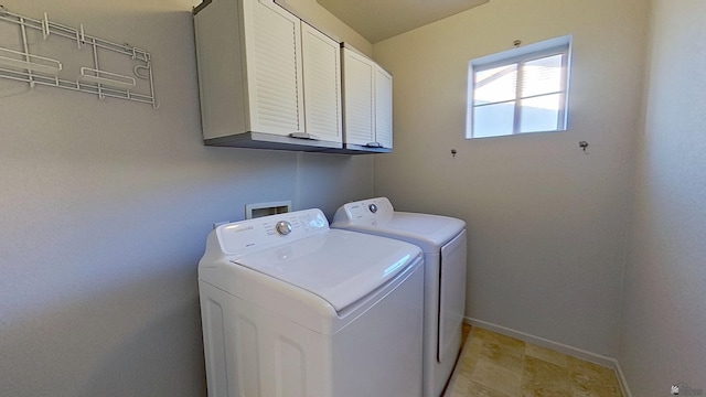 clothes washing area featuring cabinet space, baseboards, and independent washer and dryer