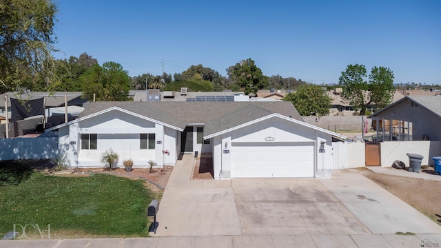 ranch-style home with a garage, fence, driveway, a gate, and stucco siding