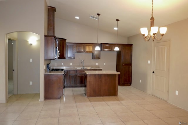 kitchen featuring sink, pendant lighting, a notable chandelier, a kitchen island, and lofted ceiling