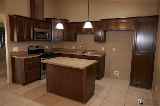 kitchen featuring sink, light tile patterned floors, pendant lighting, a kitchen island, and appliances with stainless steel finishes