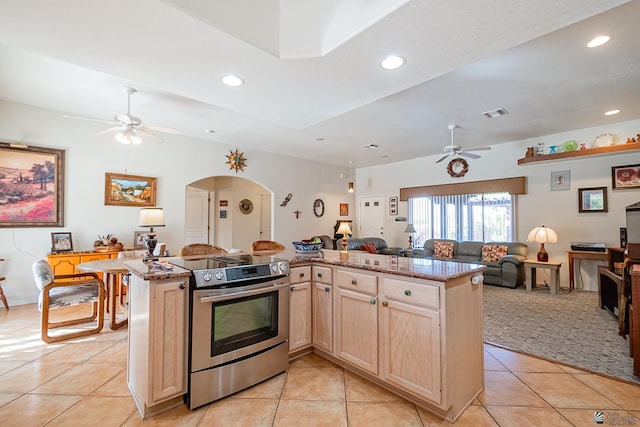 kitchen featuring light tile patterned flooring, light brown cabinetry, stainless steel range with electric stovetop, and ceiling fan