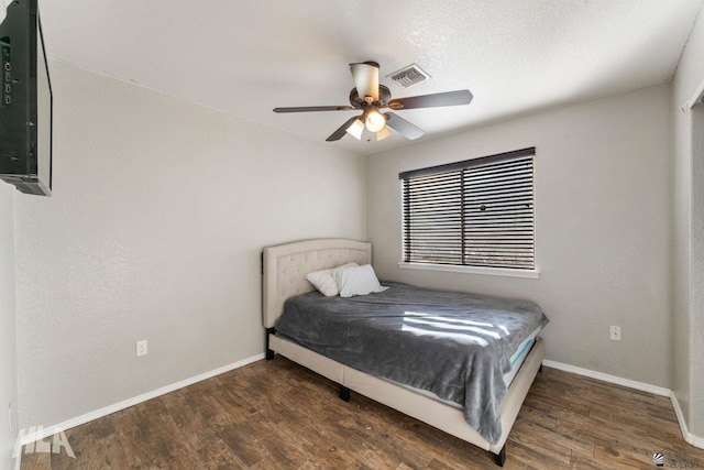 bedroom featuring dark hardwood / wood-style floors and ceiling fan