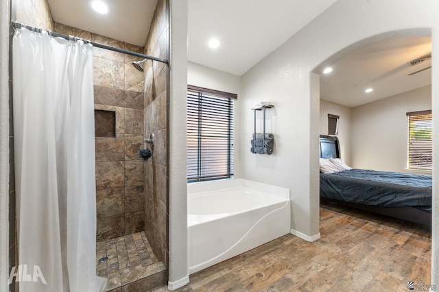 bathroom with hardwood / wood-style flooring and separate shower and tub