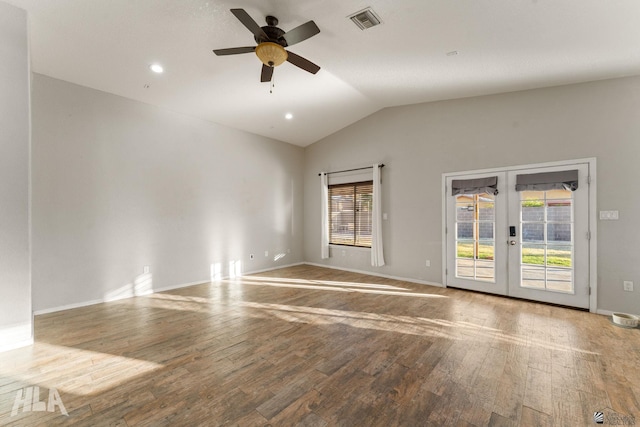 empty room with french doors, wood-type flooring, vaulted ceiling, and a wealth of natural light