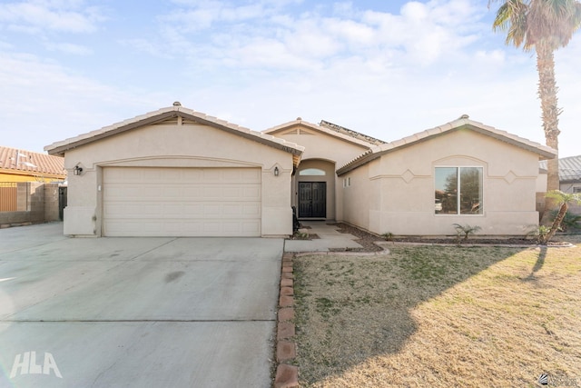 view of front facade with a garage and a front lawn