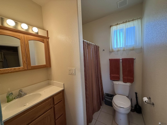 bathroom featuring toilet, vanity, tile patterned floors, and curtained shower