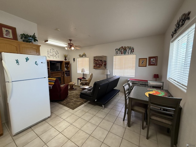 kitchen with ceiling fan, white fridge, and light tile patterned flooring