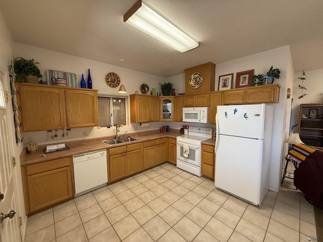 kitchen featuring a textured ceiling, sink, light tile patterned flooring, and white appliances