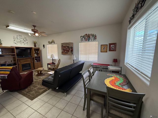 living room with ceiling fan and light tile patterned floors