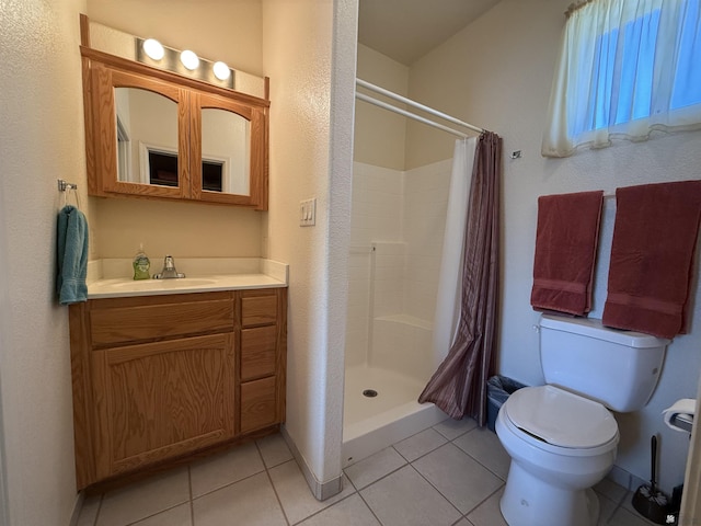 bathroom with a shower with curtain, tile patterned flooring, vanity, and toilet