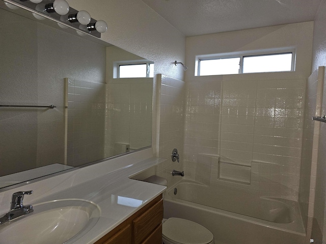 full bathroom featuring bathing tub / shower combination, vanity, a healthy amount of sunlight, and toilet