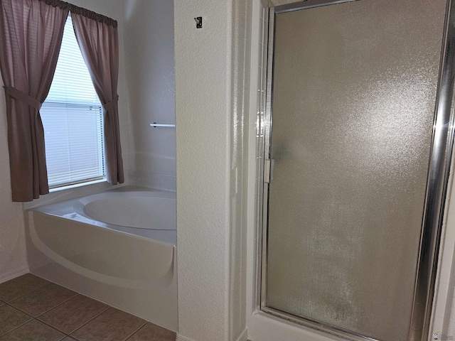 bathroom featuring tile patterned flooring and independent shower and bath