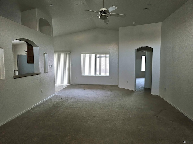 unfurnished living room with ceiling fan, carpet, and high vaulted ceiling