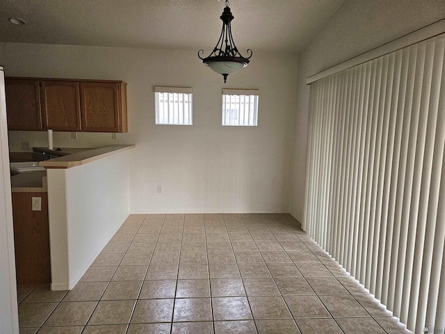 unfurnished dining area featuring sink and light tile patterned floors