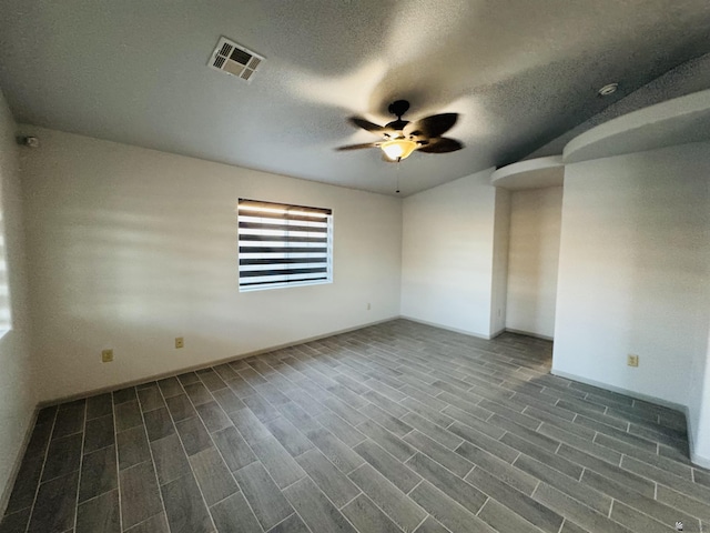 unfurnished room featuring a textured ceiling, dark hardwood / wood-style floors, and ceiling fan