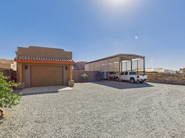 exterior space with a tile roof, fence, and stucco siding