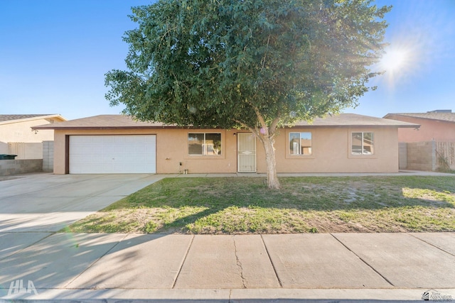 view of front of house with a garage and a front yard