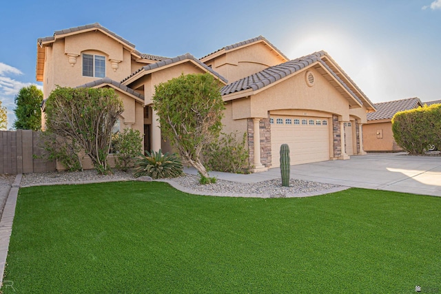 mediterranean / spanish house featuring a front yard and a garage