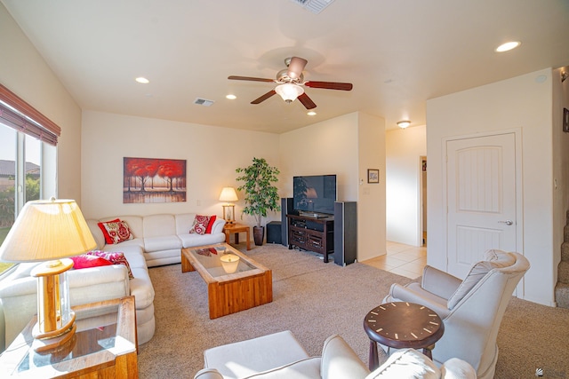 carpeted living room with ceiling fan