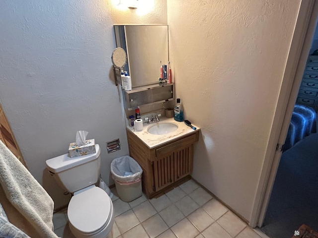 bathroom featuring toilet, vanity, tasteful backsplash, and tile patterned floors