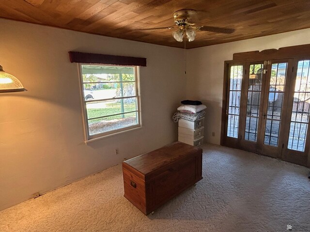 interior space featuring ceiling fan, french doors, carpet floors, and wood ceiling