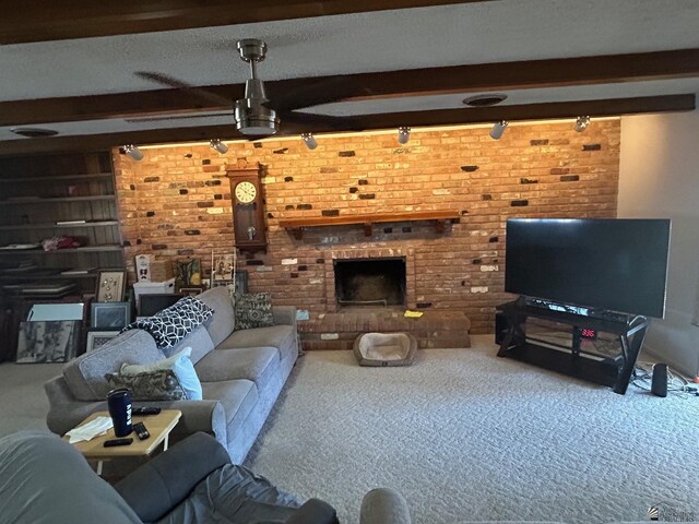 carpeted living room featuring beamed ceiling and a brick fireplace