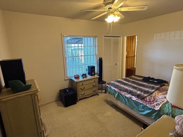 carpeted bedroom featuring a closet and ceiling fan