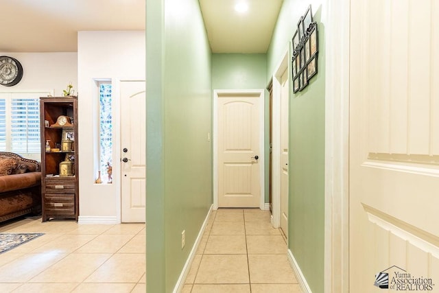 hall with light tile patterned floors