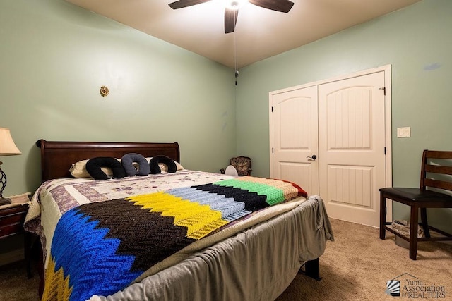 carpeted bedroom featuring ceiling fan and a closet