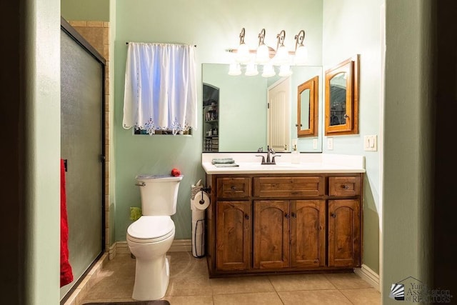 bathroom with tile patterned floors, a shower with door, vanity, and toilet