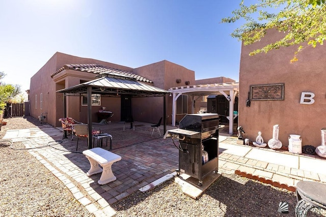 view of patio / terrace with a gazebo and a pergola