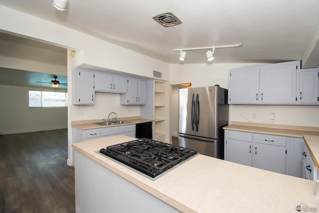 kitchen with visible vents, freestanding refrigerator, light countertops, a sink, and black gas stovetop