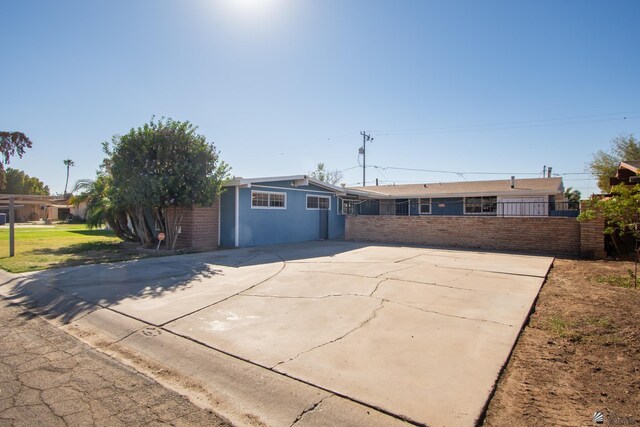 ranch-style house featuring fence