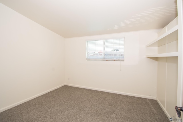 unfurnished room with carpet flooring and baseboards