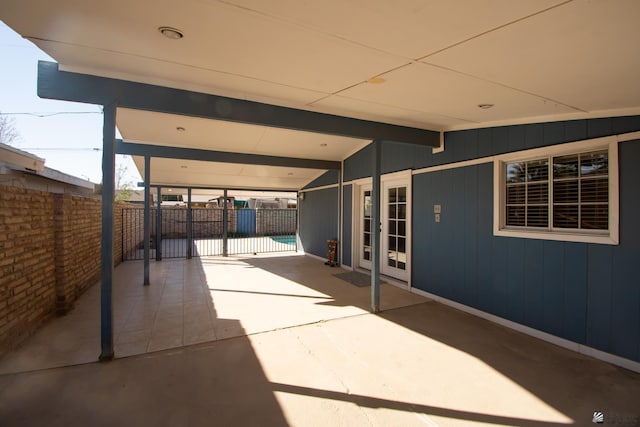 view of patio / terrace with a carport and fence