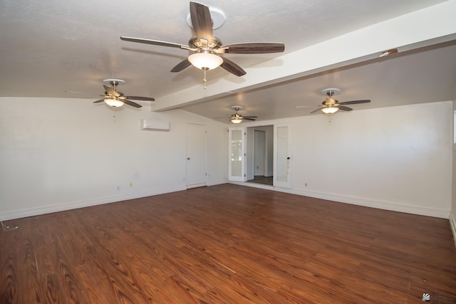 unfurnished room with a wall unit AC, dark wood-style floors, vaulted ceiling with beams, and baseboards