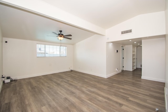 unfurnished room featuring lofted ceiling with beams, dark wood-style flooring, visible vents, and baseboards