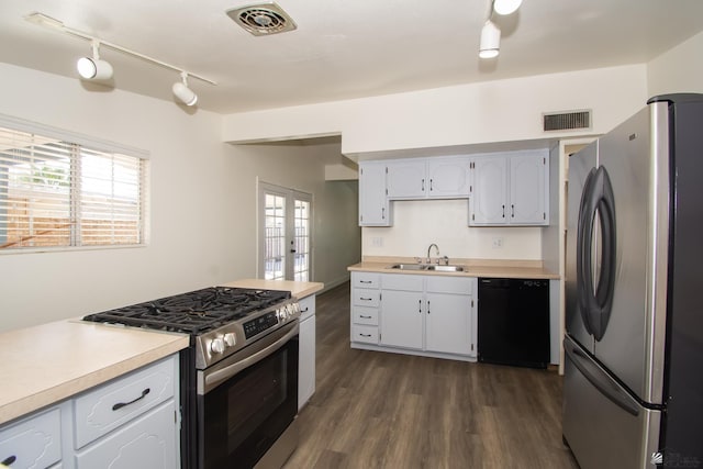 kitchen featuring stainless steel appliances, light countertops, and visible vents