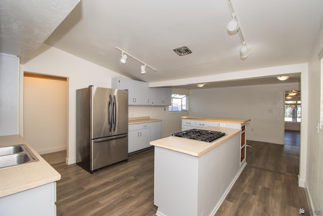 kitchen featuring gas cooktop, visible vents, white cabinets, light countertops, and freestanding refrigerator