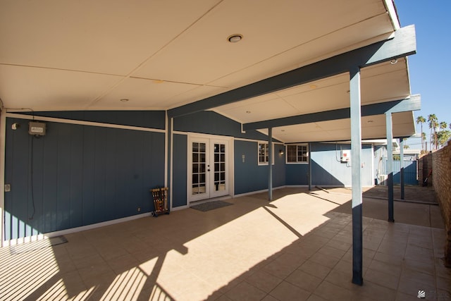 view of patio with french doors and fence