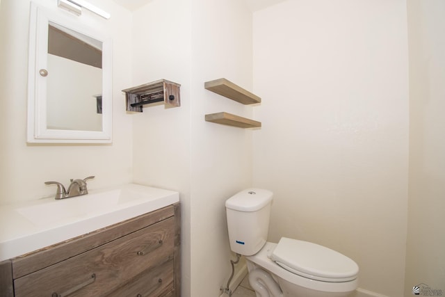 half bathroom featuring toilet and vanity