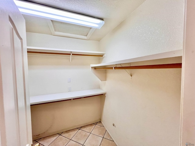 walk in closet featuring light tile patterned floors