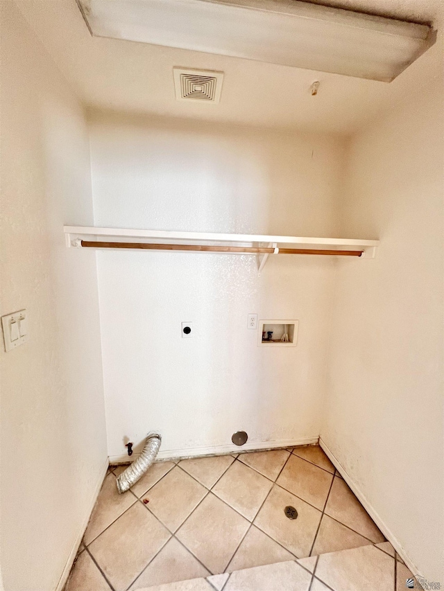 clothes washing area with hookup for an electric dryer, tile patterned floors, and hookup for a washing machine