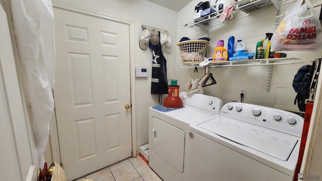 washroom with light tile patterned floors, laundry area, and separate washer and dryer