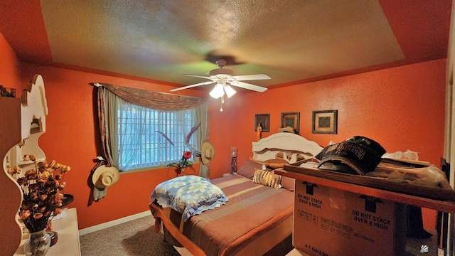 bedroom featuring a textured ceiling, carpet floors, baseboards, ceiling fan, and a textured wall