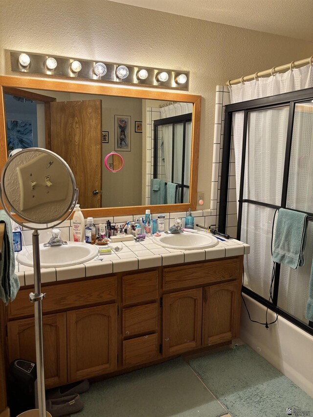 bathroom with vanity, bath / shower combo with glass door, and tile patterned floors