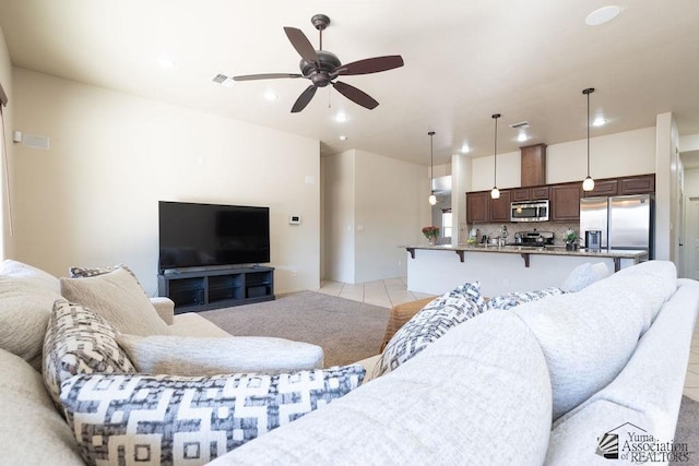 living room featuring light tile patterned floors, recessed lighting, visible vents, and a ceiling fan