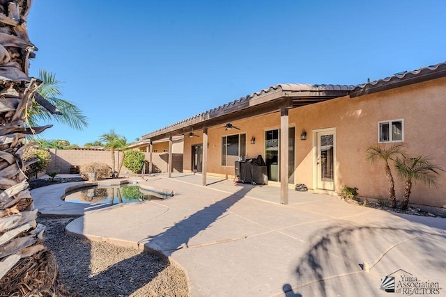 rear view of property featuring a fenced in pool, a fenced backyard, ceiling fan, a patio area, and stucco siding