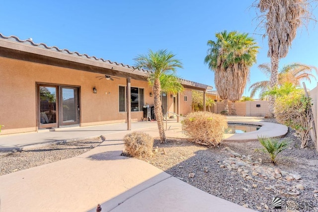 view of yard with ceiling fan, fence, and a patio