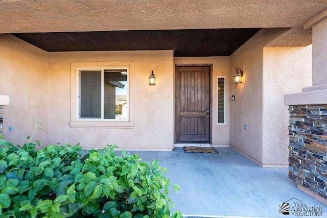 property entrance with stucco siding